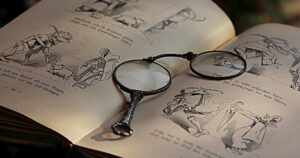 old spectacles on newspaper